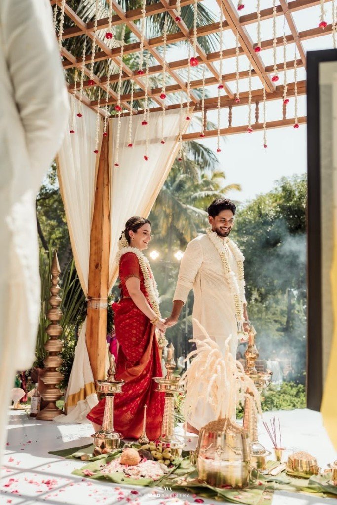Destination wedding ceremony under a floral canopy