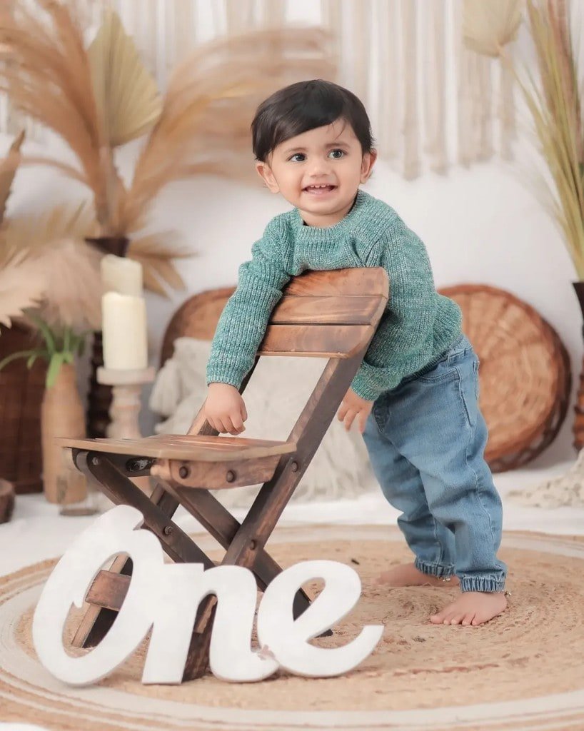 First birthday studio portrait with a One sign