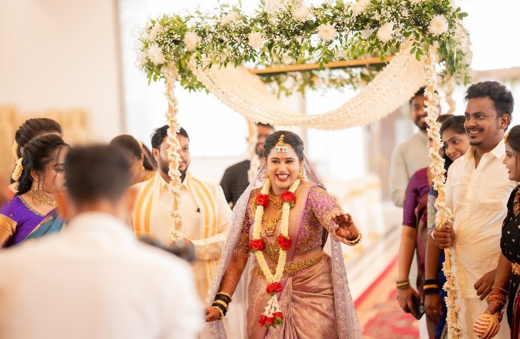 Bride walking under a floral canopy