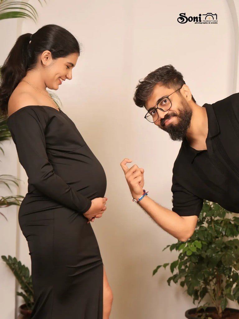 Couple maternity portrait in black studio attire