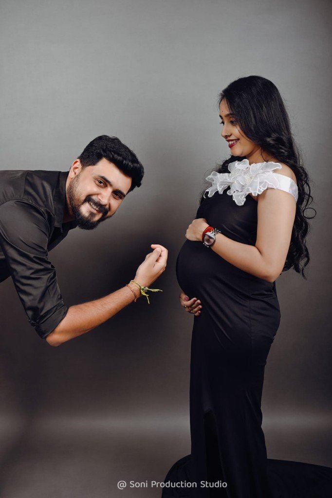 Couple maternity portrait in black studio attire