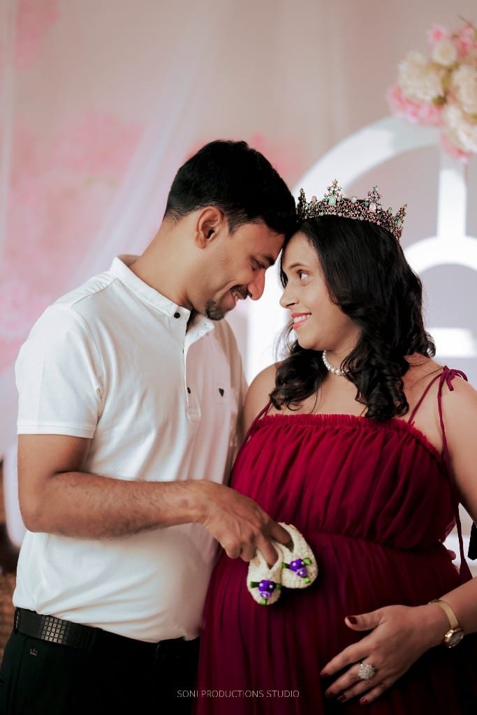 Maternity couple with baby booties