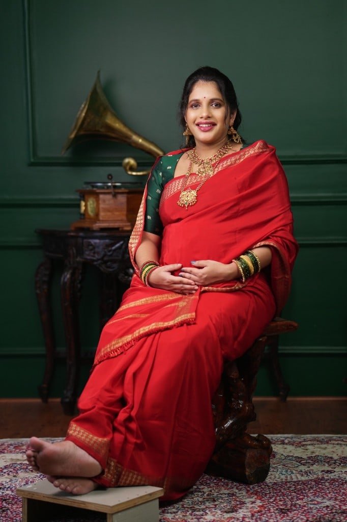 Maternity portrait in a red silk saree
