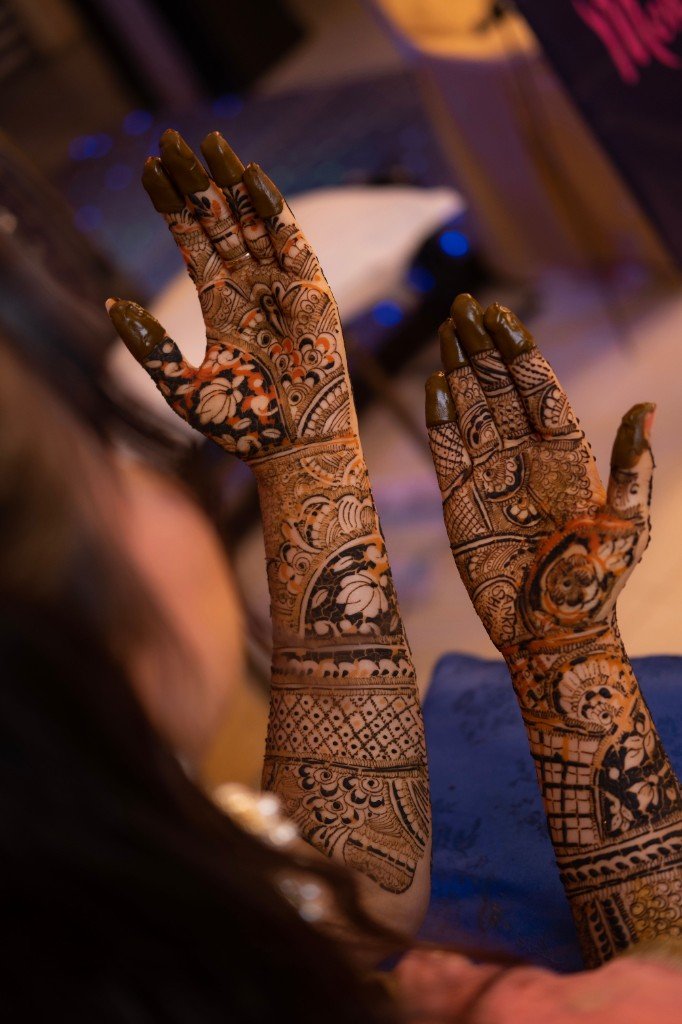 Intricate bridal mehendi on hands and forearms