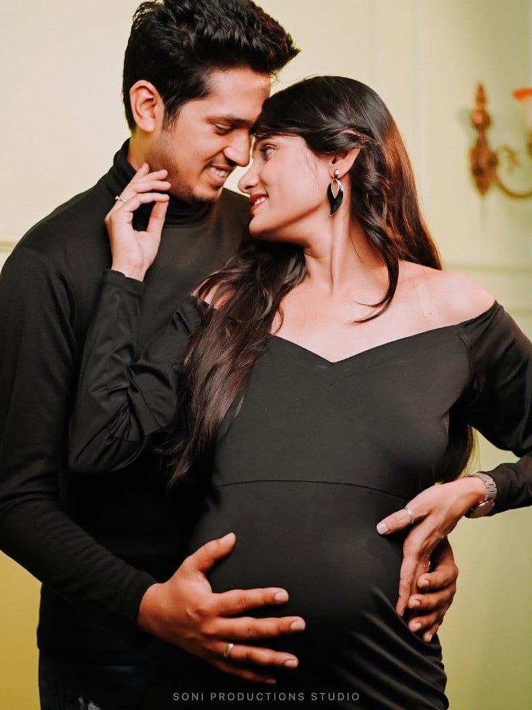 Couple maternity portrait in black studio attire