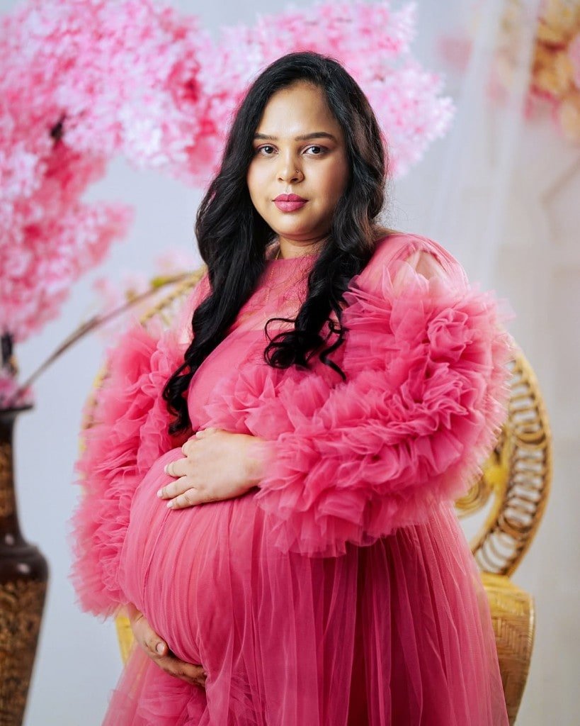 Maternity portrait in a ruffled pink gown