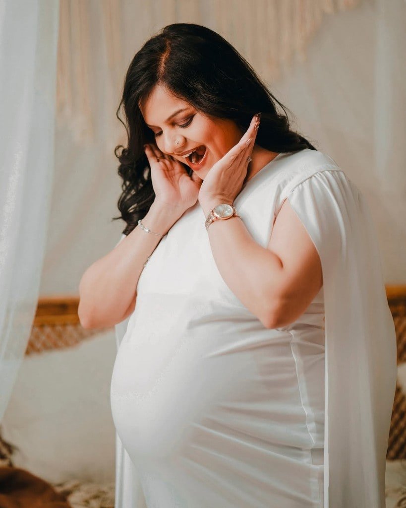 Maternity portrait in a white studio gown