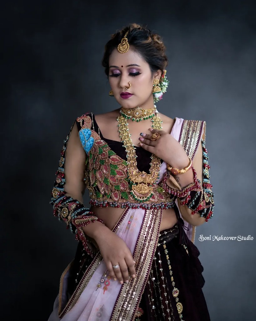 Bridal makeup with peacock embroidery and gold jewellery