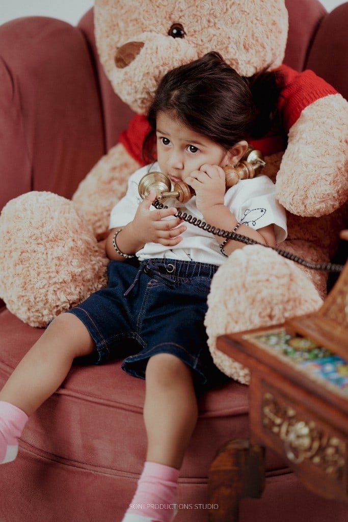 Child studio portrait with vintage telephone
