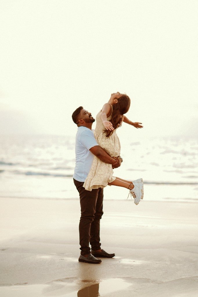 Playful pre-wedding portrait on the beach