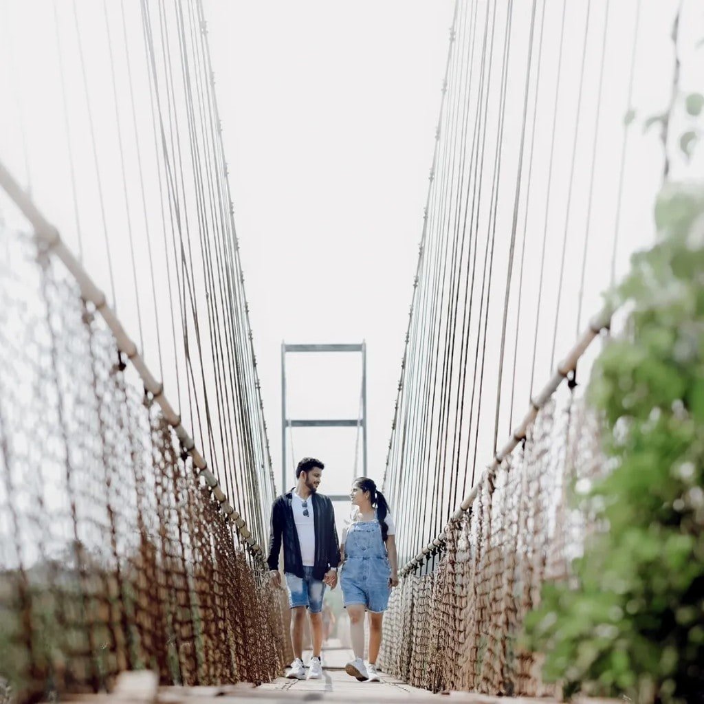 Couple walking a suspension bridge