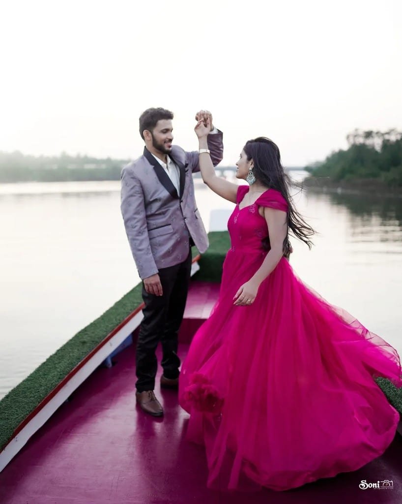 Pre-wedding twirl on the water in a magenta gown