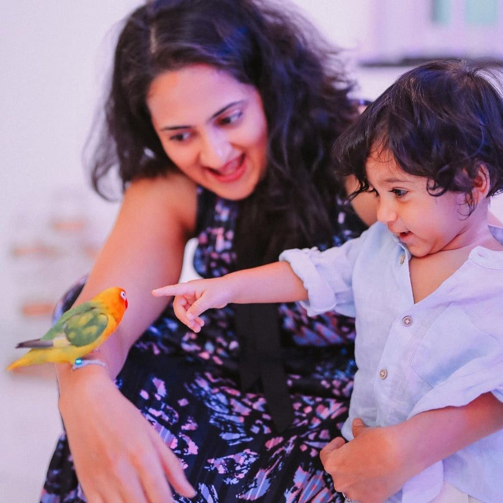 Toddler with mum and a lovebird