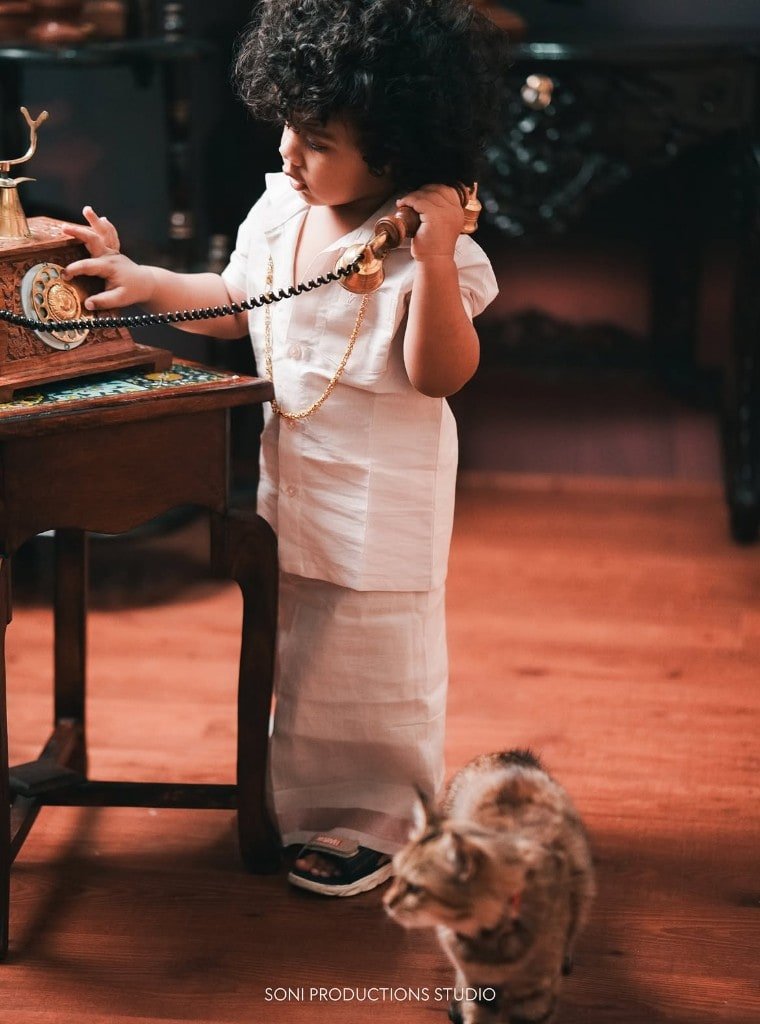 Toddler studio portrait with a vintage telephone