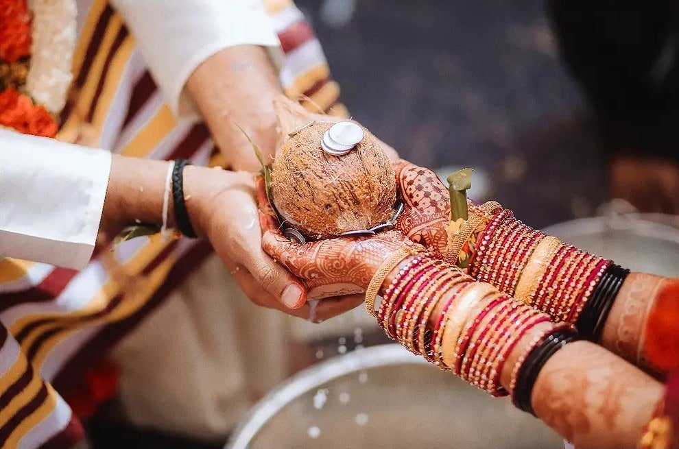 Wedding coconut ritual with joined hands