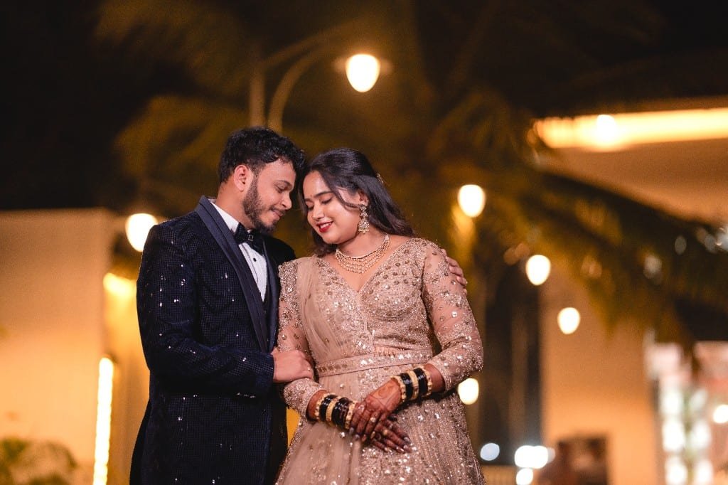 Wedding couple under night lights in gold attire