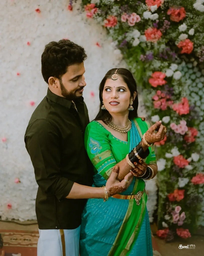 Wedding couple portrait with floral backdrop